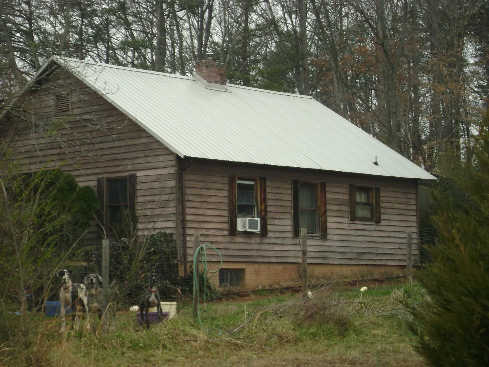 White metal roof on an old wood sided farmhouse, from a Metal Roof Installation job in Gordonsville